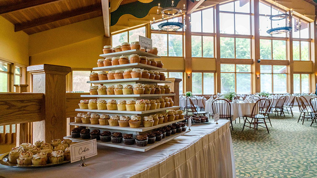 A delicious looking dessert table set up for a wedding.